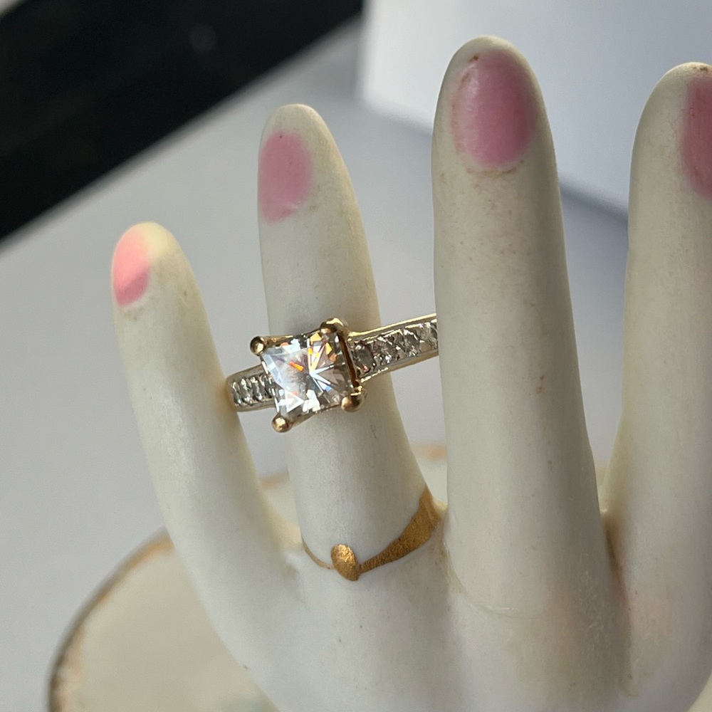 14k gold Moissanite 1k ring with diamond chip accents.